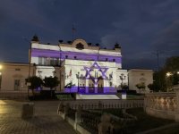 Parliament's building lit up in the colours of the Israeli flag